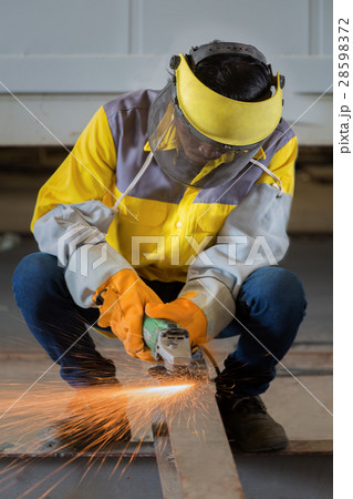 Worker work hard with the Electric wheel grinding 28598372