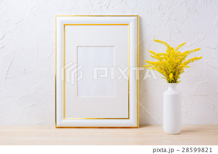 Gold decorated frame mockup with yellow grass 28599821