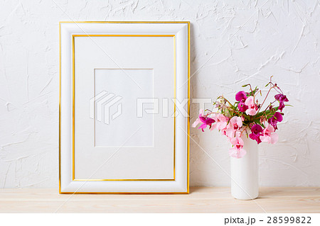 Gold decorated frame mockup with purple bouquet 28599822