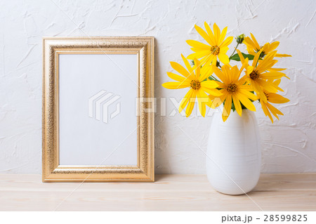 Golden frame mockup with yellow flowers in vase 28599825