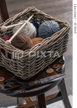 scissors and yarn inside old basket wooden chair scissors and yarn inside old basket wooden chair 28603461