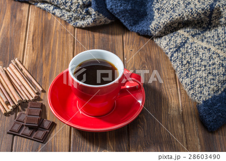 Coffee, chocolate and blanket on wooden floor Coffee, chocolate and blanket on wooden floor 28603490