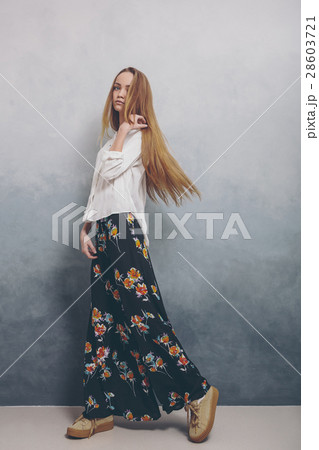 Fashion teenager girl standing on floor against Fashion teenager girl standing on floor against 28603721