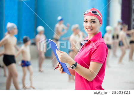 Instructor and group of children doing exercises 28603821