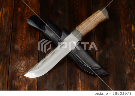 Hunting knife handmade on a wooden background Hunting knife handmade on a wooden background 28603973