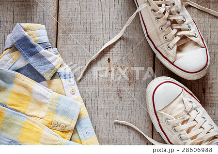Shirt and sneakers on wooden. 28606988