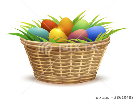Wicker basket full of Easter eggs on grass 28610488
