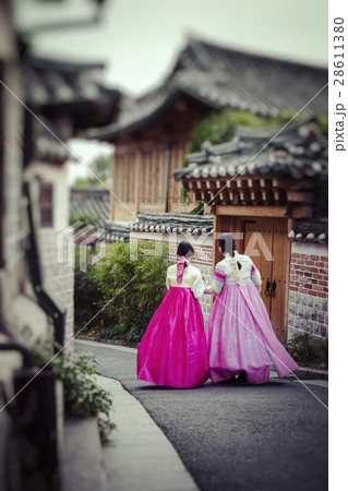 A couple women wander through the traditional styl A couple women wander through the traditional styl 28611380