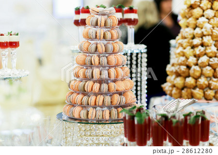 Orange and violet macaroons served as a pyramid Orange and violet macaroons served as a pyramid 28612280