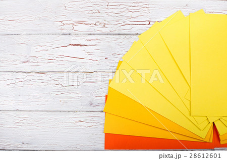 Papers in shades of orange and yellow lie Papers in shades of orange and yellow lie 28612601