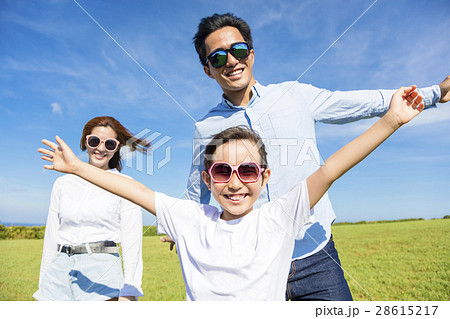 Happy young family playing on the grass 28615217