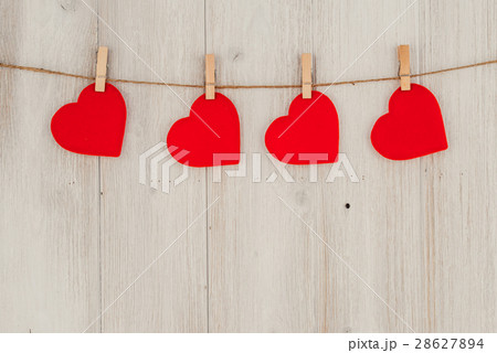 Red heart hanging on the clothesline. On old wood 28627894
