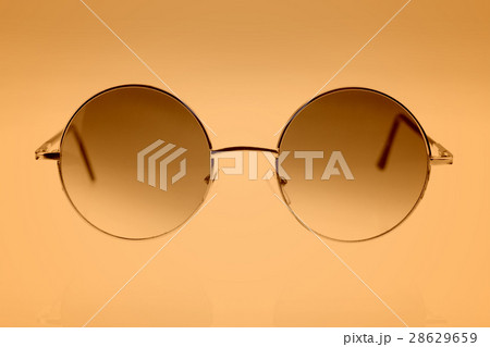Eyeglasses on brown background 28629659
