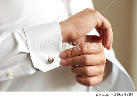 Man correcting the sleeve of his shirt 28634884