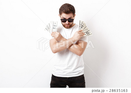 handsome serious man with beard in shirt holding a 28635163