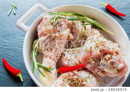 Raw chicken legs (drumsticks) in white baking dish 28636974
