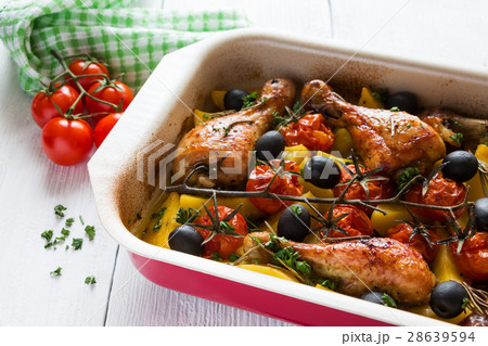 Baked chicken drumsticks in red dish Baked chicken drumsticks in red dish 28639594