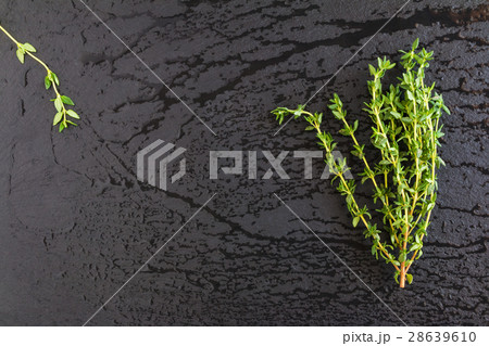Bunch of thyme herb on black stone background 28639610