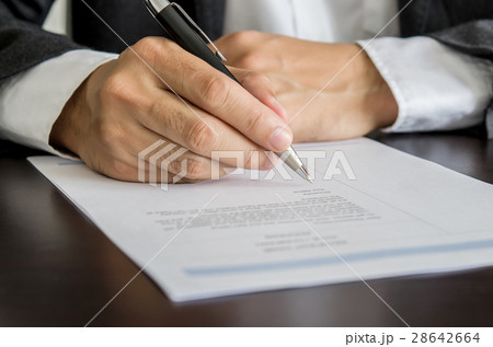 Businessman or job seeker signing on resume form. Businessman or job seeker signing on resume form. 28642664