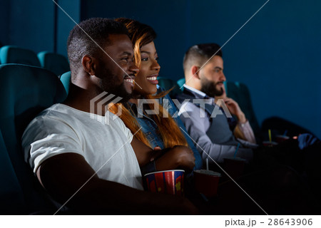 Happy African couple at the cinema Happy African couple at the cinema 28643906