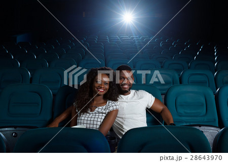 Happy African couple at the cinema Happy African couple at the cinema 28643970