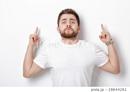 handsome man with beard pointing up. young man handsome man with beard pointing up. young man 28644261