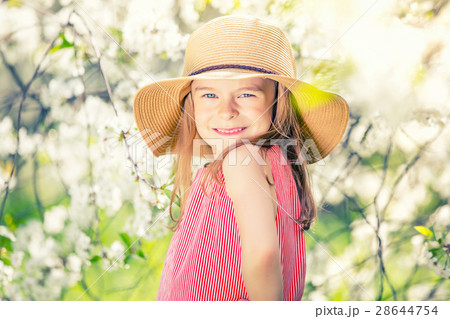Happy little girl in cherry blossom garden Happy little girl in cherry blossom garden 28644754