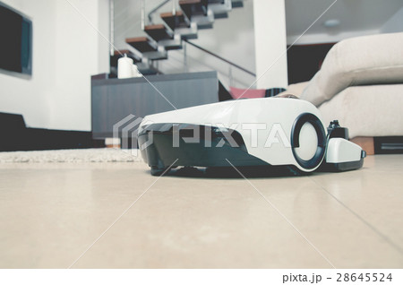 Robot vacuum cleaner working in modern home 28645524