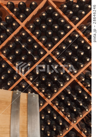 Glass Wine Bottles and Barrel Age In Wine Cellar 28646246