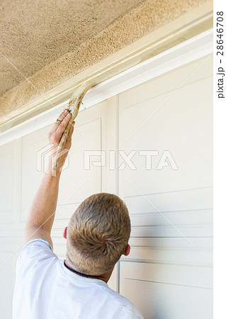 Professional Painter Cutting In With Brush to Paint Garage Door Professional Painter Cutting In With Brush to Paint Garage Door 28646708