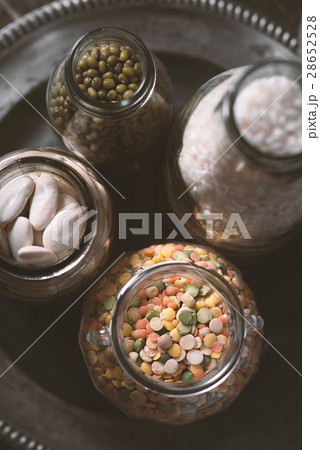 Beans, lentils, rice in a glass jar on a plate Beans, lentils, rice in a glass jar on a plate 28652528
