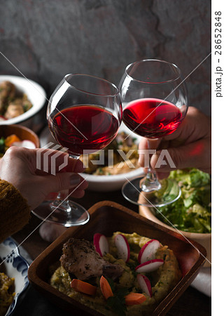 Glasses with a drink in his hand and a festive 28652848