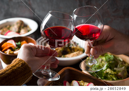 Glasses with a drink in his hand and a festive 28652849