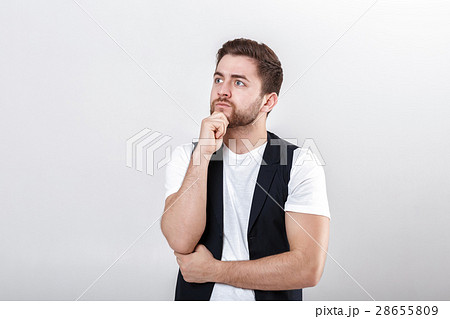portrait of handsome pensive brunette man in white 28655809