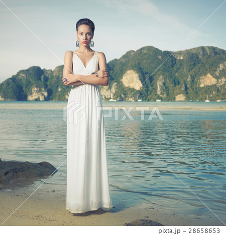 Lady in white dress on a seashore Lady in white dress on a seashore 28658653