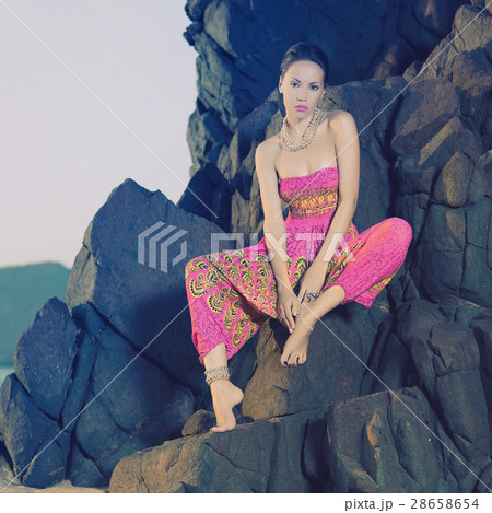 Glamorous beauty on rocky shore 28658654