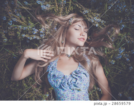 Beautiful lady lying amond flowers Beautiful lady lying amond flowers 28659579