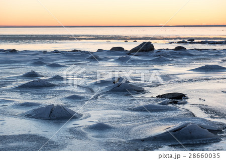 Sunset view at an ice covered coastline 28660035