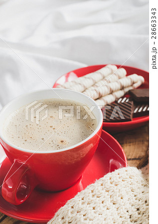 Cappuccino and Chocolate on a Bed with Plaid. Cappuccino and Chocolate on a Bed with Plaid. 28663343