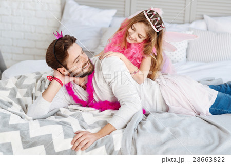 Delighted smiling male looking at his daughter 28663822