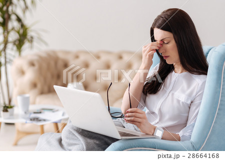 Exhausted sad woman suffering from the headache Exhausted sad woman suffering from the headache 28664168