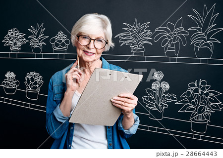Nice aged woman working in the flower shop 28664443