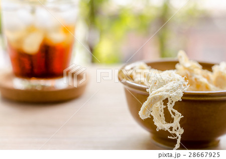 close up in dried squid and cola in glass 28667925
