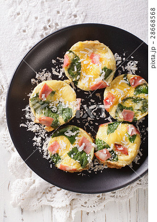 frittata with spinach, ham and cheese on a plate frittata with spinach, ham and cheese on a plate 28668568