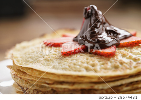premium dark chocolate poured on blinis with 28674431