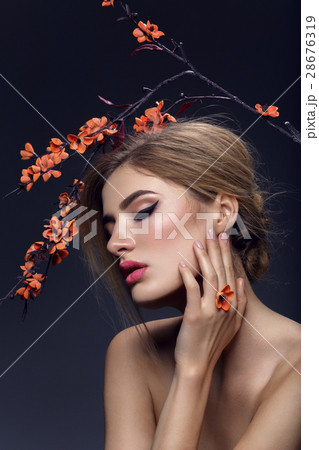 Beautiful girl with sakura branch 28676319