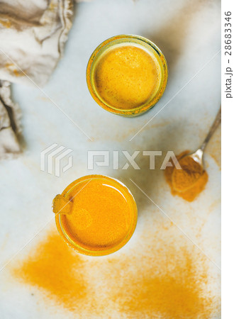 Golden milk with turmeric powder in glasses 28683346
