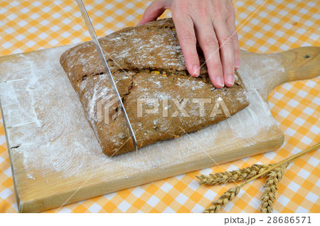 Cutting Dark Bread 28686571