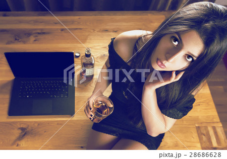 Brunette woman sitting on wooden office 28686628