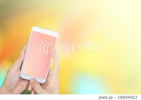 hand holding smart phone on abstract background 28694922